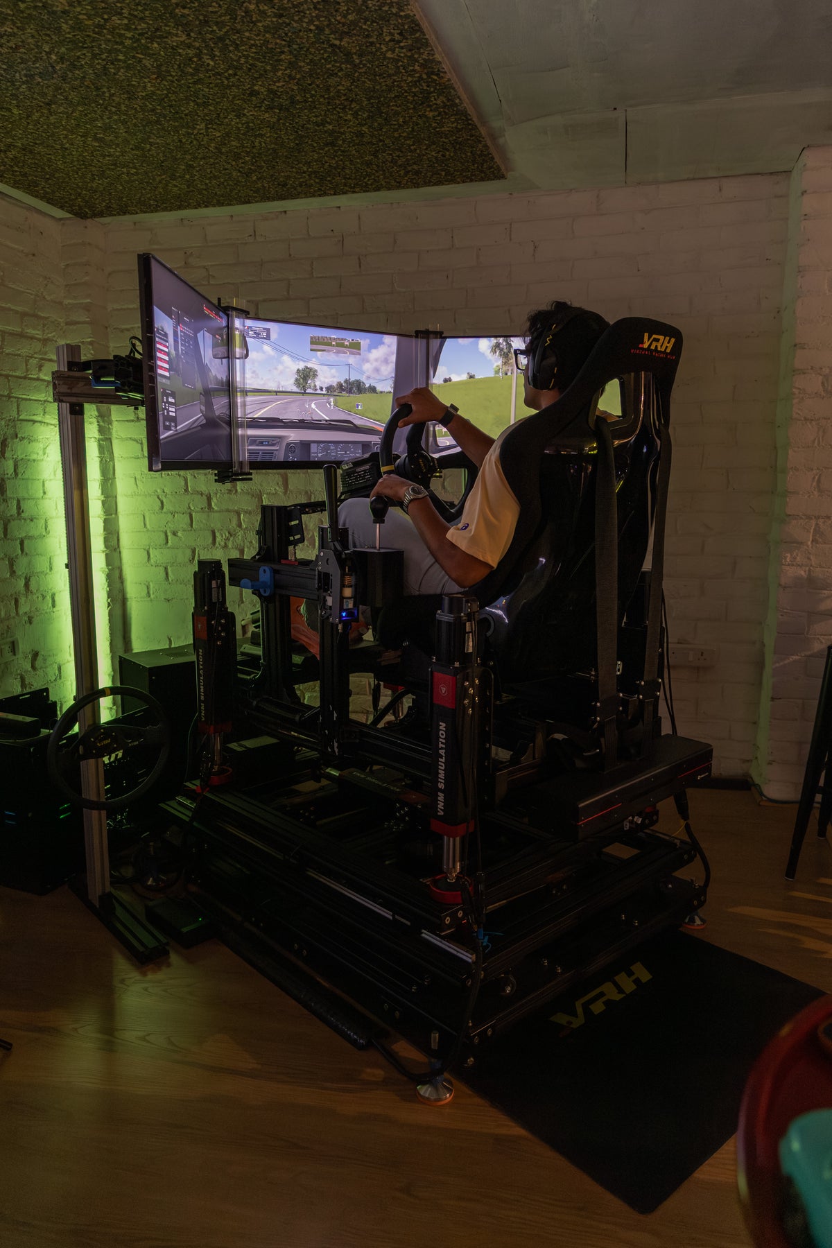 Driver on a VNM 6DoF motion racing simulator with triple screens, home-installed by Virtual Racing Hub in India
