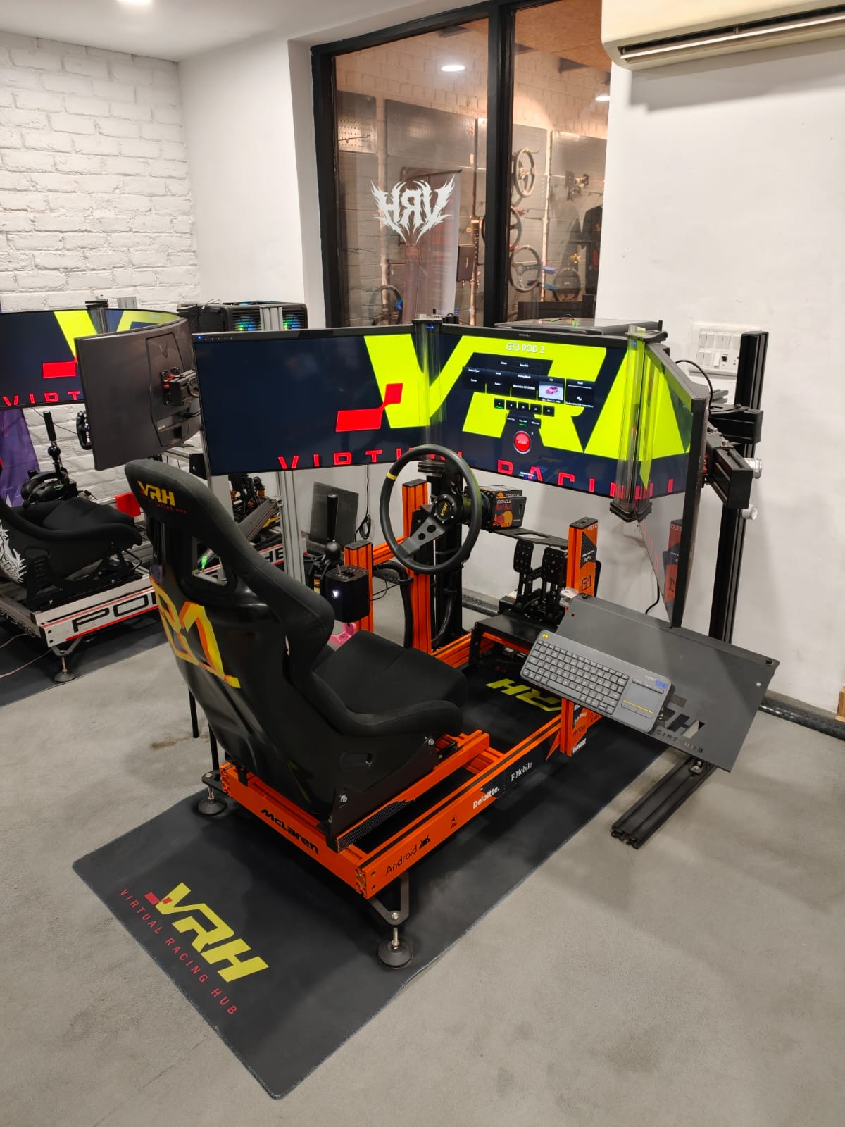 GT3 racing simulator pod with triple screens and direct drive wheel at Virtual Racing Hub